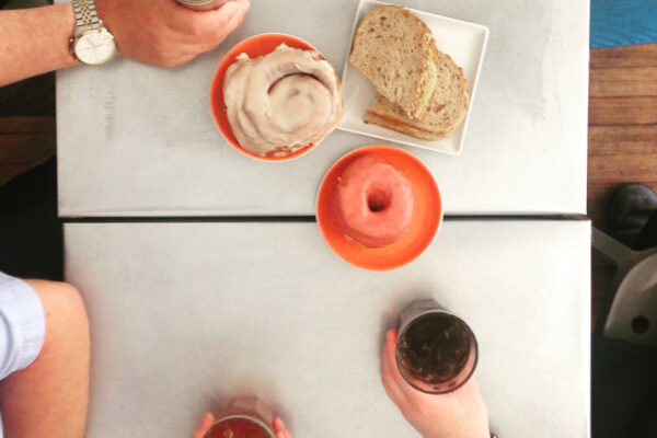 Top view of a cafe table with donuts and drinks