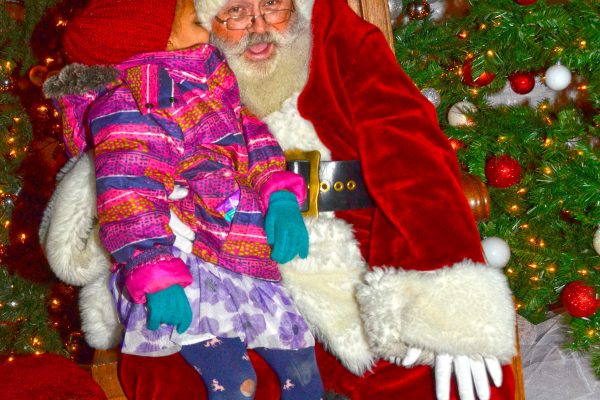 2018 Victorian Night. Girl posing for a picture with Santa.