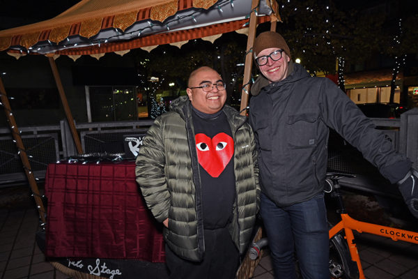 2019 Victorian Night. Two people smiling in front of vendor stand.
