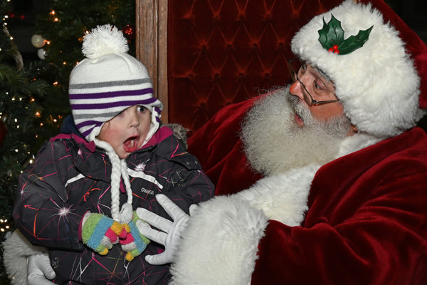 2019 Victorian Night. Child sitting on Santa's lap making funny faces.