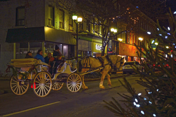 2019 Victorian Night. Group of people enjoying a ride on a horse drawn carriage.