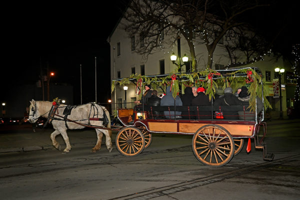 2019 Victorian Night. Group of people enjoying a ride on a horse drawn carriage.