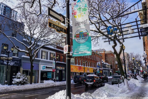 Image of snow on King St,. East with a banner in the foreground